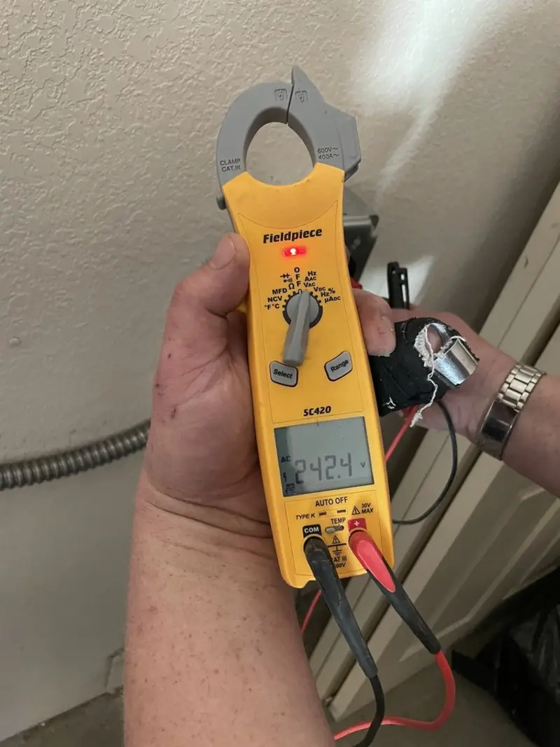 Voltage testing with clamp meter during Recessed Lighting Installation in Collinsville